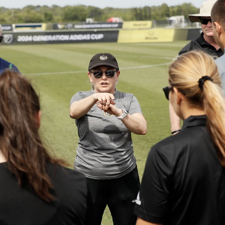 OMG referee coach giving instruction on the field